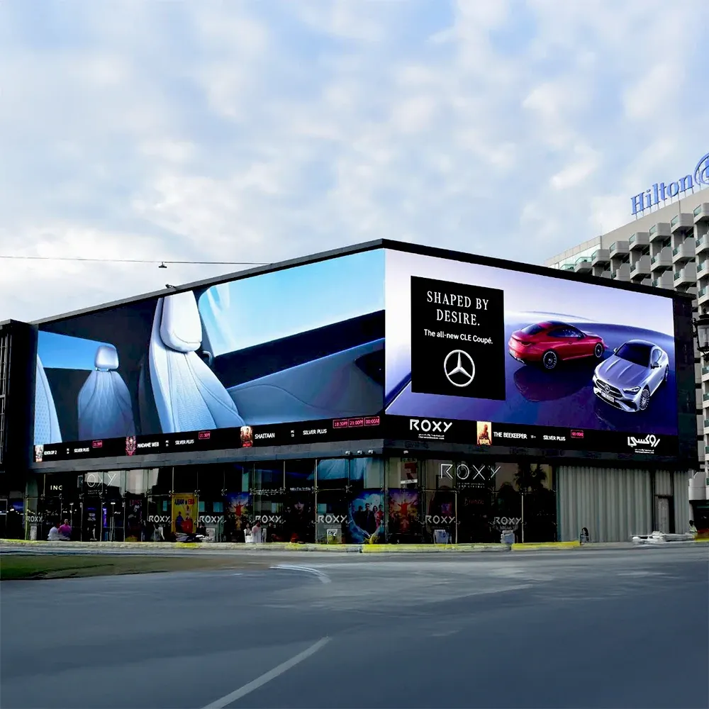 Bvlgari Serpenti digital unipole billboard advertising on a waterfront road in Dubai — luxury jewellery campaign displayed on large-format LED outdoor advertising structure with skyline and sea backdrop.