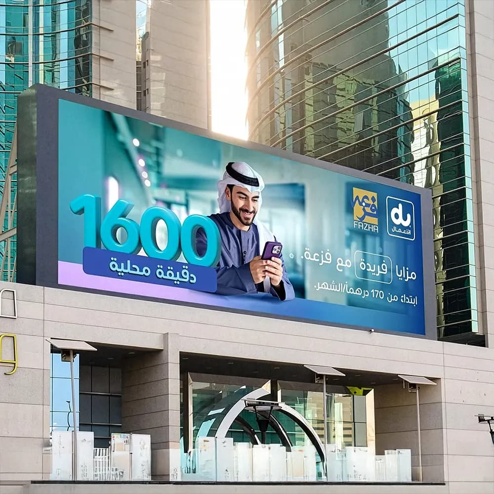 du and Fazaa rooftop billboard advertising in Dubai — large-format building-mounted outdoor display promoting 1600 local minutes offer starting from AED 170/month, positioned in a high-rise commercial district.