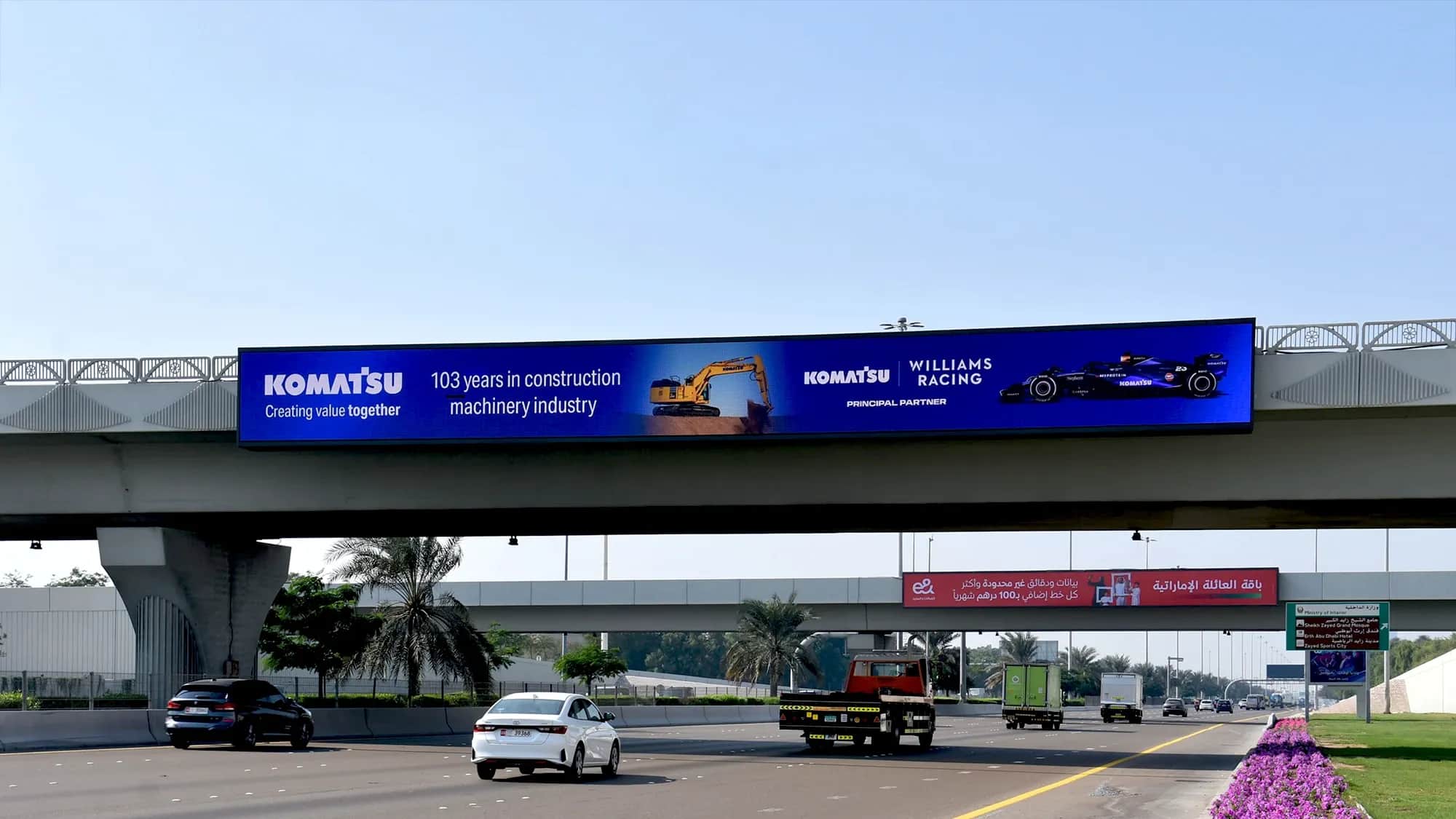 Komatsu bridge banner advertising placement on major highway Sheikh Zayed Road, Dubai for outdoor brand visibility